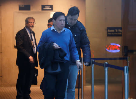 Liu Xiaozong (rear R), husband of Huawei CFO Meng Wanzhou, returns to his wife's B.C. Supreme Court bail hearing after a lunch recess in Vancouver, British Columbia, Canada December 11, 2018. REUTERS/Lindsey Wasson