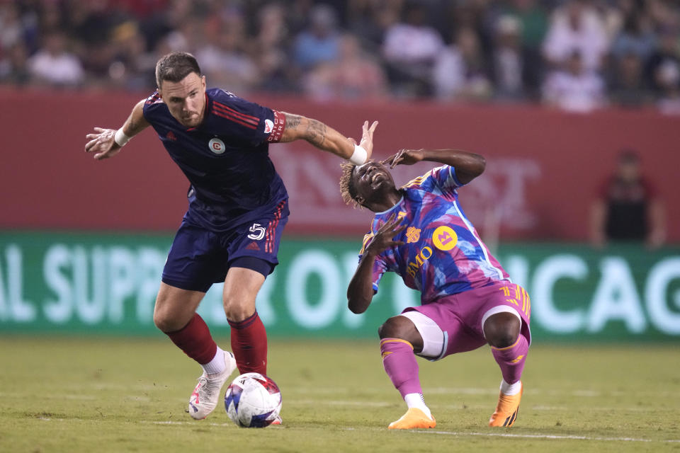 Chicago Fire defender Rafael Czichos, left, fouls Toronto FC's Latif Blessing in the second half of an MLS soccer match Saturday, July 15, 2023, in Chicago. (AP Photo/Charles Rex Arbogast)