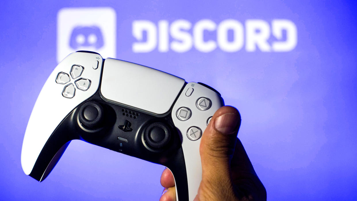  In this photo illustration, a PlayStation 5 controller seen with a Discord logo in the background. . 