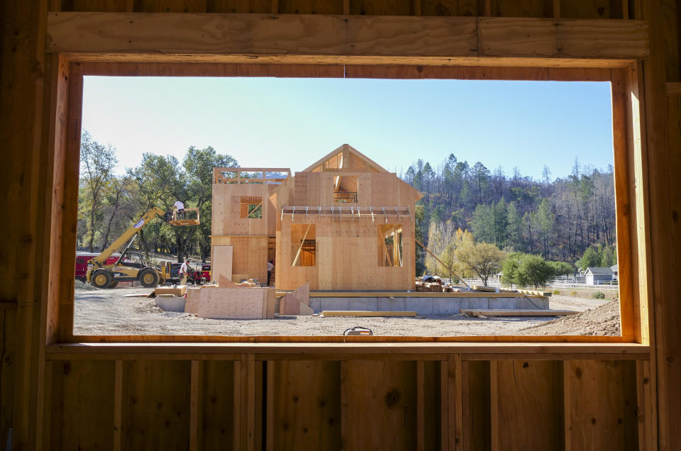 In this Monday, Nov. 4, 2019, photo, members of the Chandler family, father Joel and sons Bobbie and Dale, and their construction crew build a home in Calistoga, Calif. They have taken on construction jobs while rebuilding and building their own homes in Santa Rosa. The Chandler family home of 20 years and thousands of other structures were destroyed by the Tubbs Fire and other wine country wildfires of 2017. The Chandler family rose from the ashes, rebuilding after losing their longtime family home to in the devastating firestorms that swept across California wine country in 2017. (AP Photo/Lacy Atkins)