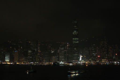 Hong Kong's Victoria harbour waterfront is seen with its lights dimmed during Earth Hour. Australia's Sydney Harbour Bridge and Opera House were plunged into darkness for the annual Earth Hour campaign, leading a global effort to raise awareness about climate change