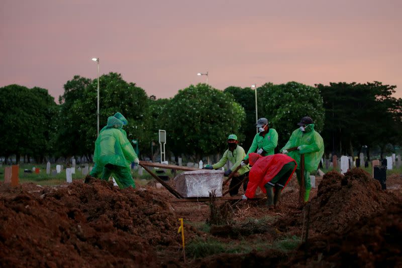 FILE PHOTO: Municipality workers bury the coffin of Ratih Purwarini, a doctor who passed away due to the coronavirus disease (COVID-19), in Jakarta