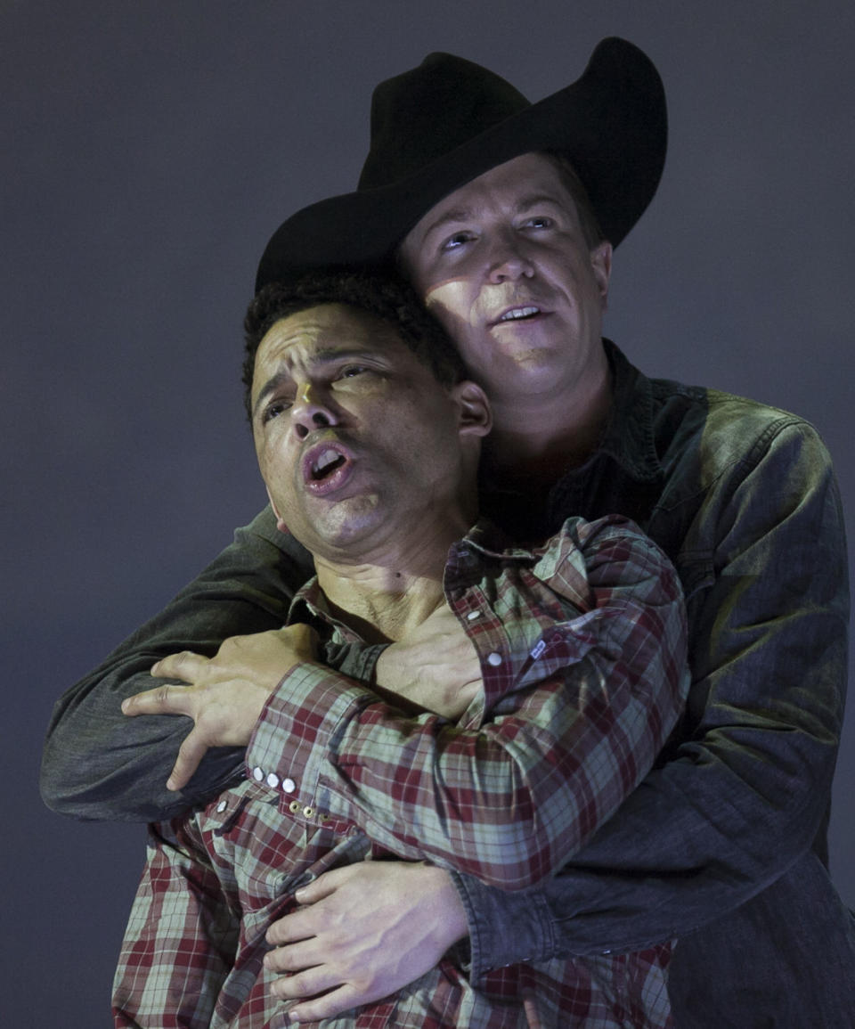 In this photo taken on Friday, Jan. 24, 2014, American tenor Tom Randle (Jack Twist), left, and Canadian bass-baritone Daniel Okulitch (Ennis del Mar), right, perform during the press rehearsal of the production "Brokeback Mountain" at the Teatro Real, in Madrid, Spain. It was a short story, then a Hollywood movie. Now the tragic tale of cowboys in love is being reinvented again: Brokeback Mountain _ the opera. Ahead of its world premiere in Madrid, author Annie Proulx told The Associated Press that the form of opera presented an opportunity to explore the complexities of the tale in a way neither her own short story nor the movie by director Ang Lee were able to do. (AP Photo/Gabriel Pecot)