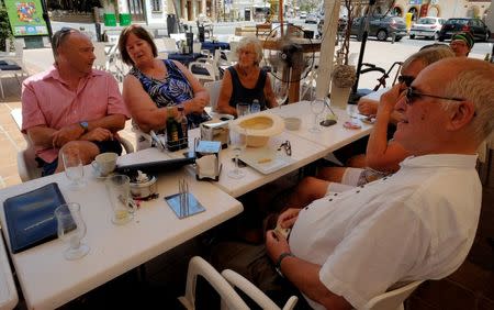 British residents discuss in a restaurant after Britain voted to leave the European Union in the EU Brexit referendum, in Javea near Alicante, Spain, June 24, 2016. REUTERS/Heino Kalis