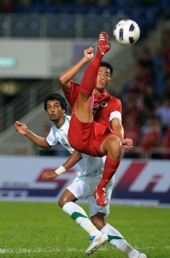 Chan Wai Ho (top) of Hong Kong battles for the ball with Yousef Al Salem of Saudi Arabia during their 2014 World Cup Asian qualifying football match at the Siu Sai Wan Sports Ground in Hong Kong. Hong Kong crashed out after a 5-0 thumping at home by Saudi Arabia to add to the 3-0 reverse they suffered in the first leg