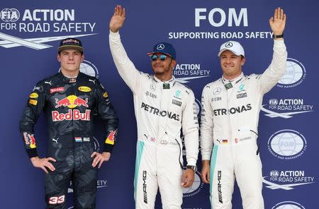 Britain Formula One - F1 - British Grand Prix 2016 - Silverstone, England - 9/7/16 Mercedes' Lewis Hamilton celebrates qualifying in pole position Mercedes' Nico Rosberg who finished in second place and Red Bull's Max Verstappen who finished in third Reuters / Matthew Childs Livepic