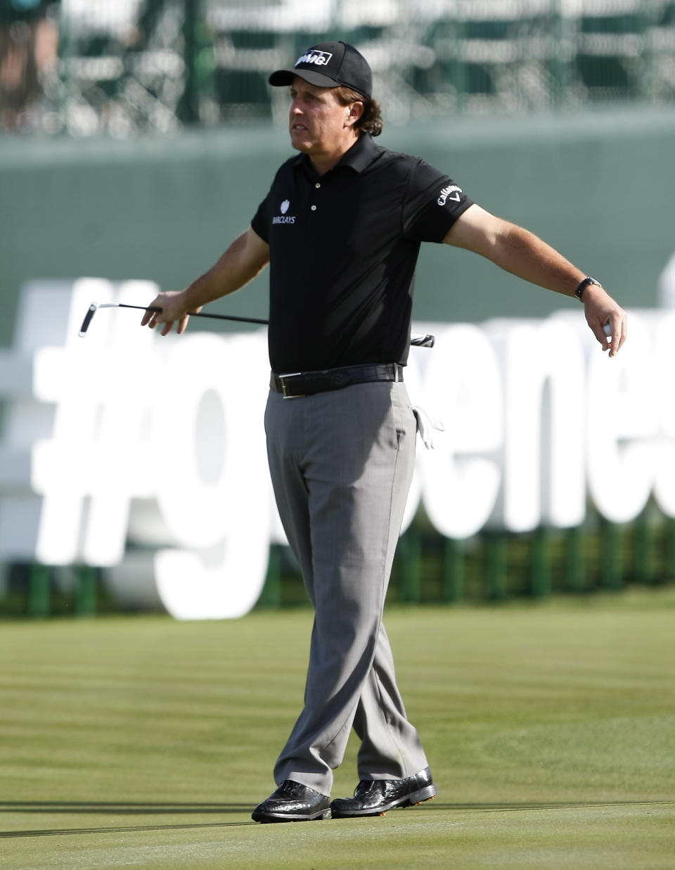Phil Mickelson stretches on the 17th hole during the first round of the Waste Management Phoenix Open golf tournament on Thursday, Jan. 30, 2014, in Scottsdale, Ariz. (AP Photo/Rick Scuteri)