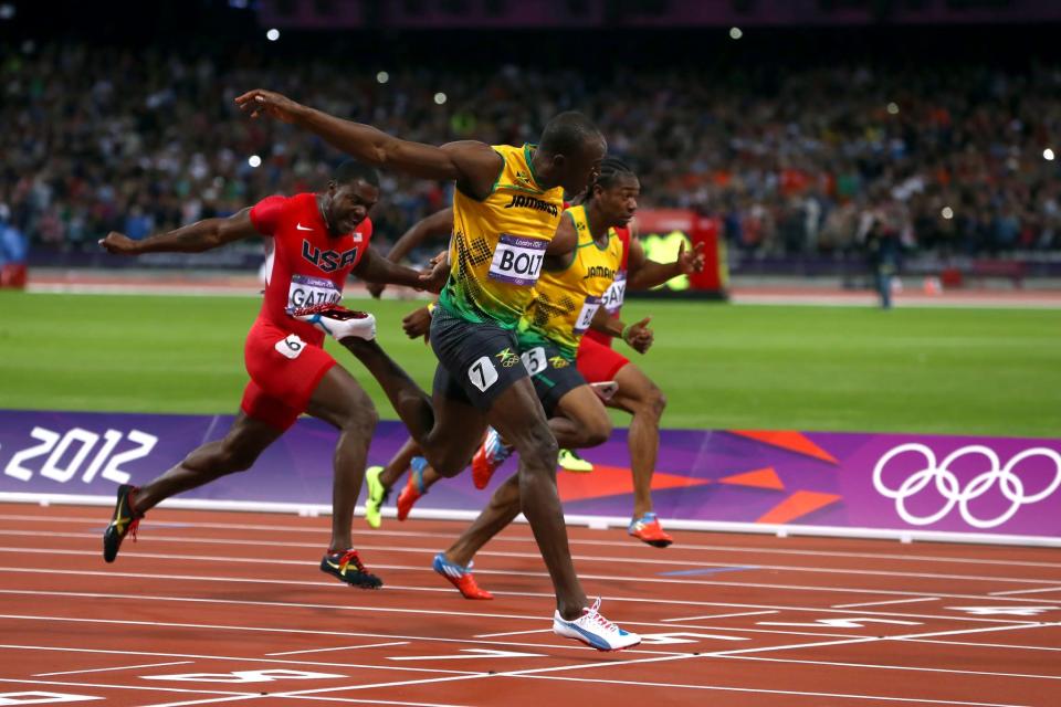 <p>Usain Bolt crosses the finish line ahead of Yohan Blake of Jamaica and Justin Gatlin of the United States to win the Men’s 100m Semifinal on Day 9 of the London 2012 Olympic Games at the Olympic Stadium on August 5, 2012 in London, England. (Getty) </p>
