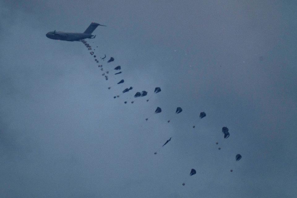 An aircraft airdrops humanitarian aid over Gaza the northern Gaza Strip, as seen from southern Israel, Friday, March 8, 2024.