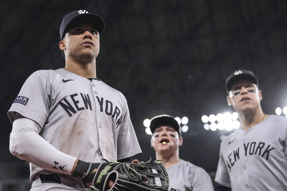 New York Yankees outfielders Juan Soto, Alex Verdugo and Aaron Judge, from left, look into the crowd as they head back to the dugout at the end of eighth inning of the team's baseball game against the Toronto Blue Jays on Friday, June 28, 2024, in Toronto. (Chris Young/The Canadian Press via AP)
