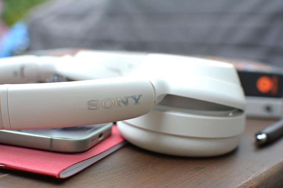 <p>Headband detail of white headphones showing Sony logo.</p>
