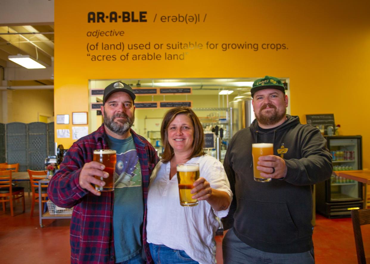 Owners Cam Wells, left, Amy Wells and Chris Archer have opened Arable Brewing in Eugene.