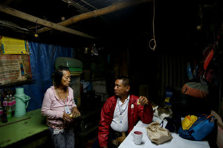 Alejandro Galasao, 58, street sweeper, eats breakfast with his wife in their home in San Jose Del Monte City, Bulacan province, Philippines, November 15, 2018. Galasao wakes up between 1:00-2:00 every day to prepare his food and clothes before going to work. REUTERS/Eloisa Lopez