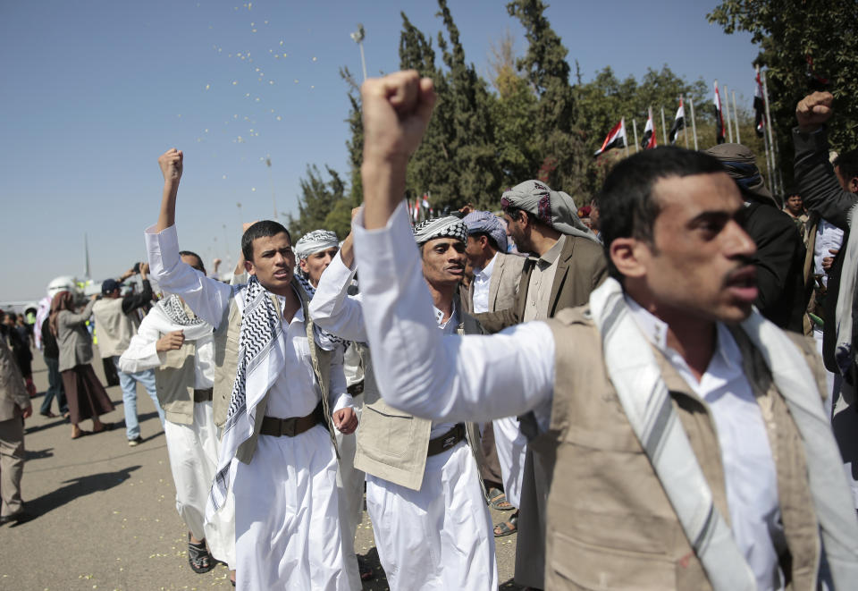 Yemeni prisoners chant slogans during their arrival after being released by the Saudi-led coalition at the airport in Sanaa, Yemen, Thursday, Oct. 15, 2020. (AP Photo/Hani Mohammed)