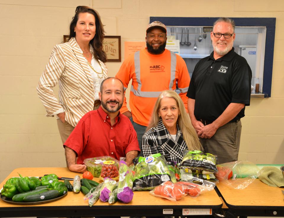 A few years ago, John Anderson asked LEAD Brevard to be part of continuing a holiday mission he championed at the Central Brevard Sharing Center in Cocoa. Though Anderson died in 2020, his devotion to those less fortunate in Brevard County lives on this and every Thanksgiving with the help of LEAD Brevard graduates including (back row) Robyn Hattaway, Alex Goins and Dave Brubaker, president and CEO of the Sharing Center, (front seated) Vinnie Taranto and Kristin Bakke.
(Credit: , MALCOLM DENEMARK/FLORIDA TODAY)