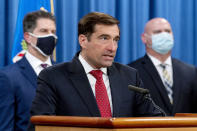 Assistant Attorney General for the National Security Division John Demers, center, accompanied by FBI Deputy Director David Bowdich, left, and FBI Special Agent in Charge of the Pittsburgh field office Michael Christman, right, speaks at a news conference at the Department of Justice, Monday, Oct. 19, 2020, in Washington. (AP Photo/Andrew Harnik, pool)