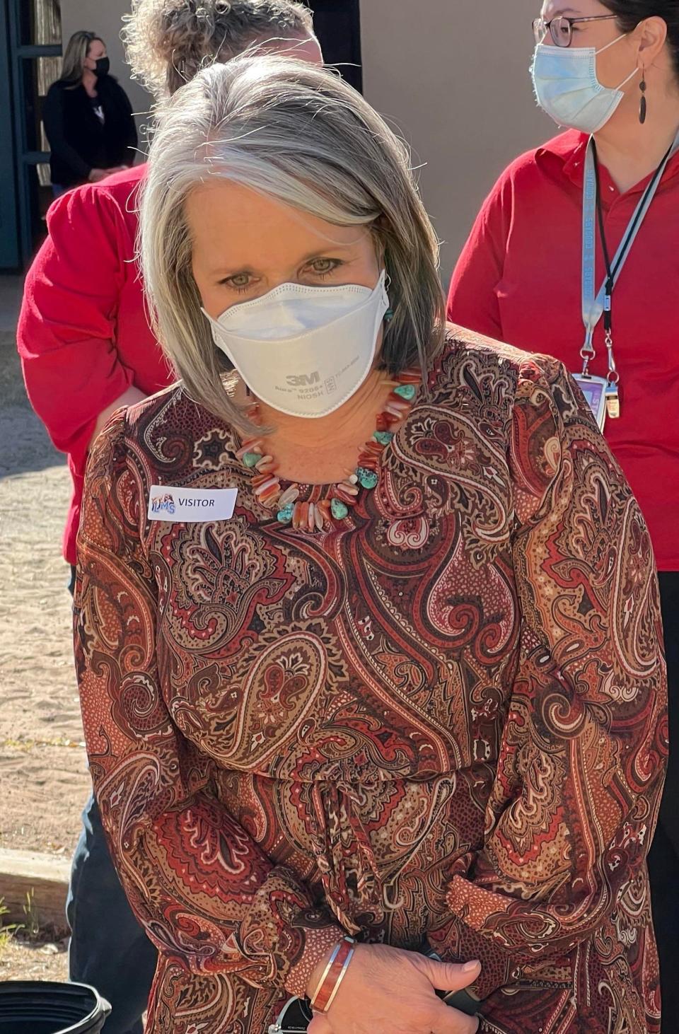 New Mexico Gov. Michelle Lujan Grisham wears an N95 mask during a visit to Lynn Middle School in Las Cruces on Friday, Nov. 12, 2021.