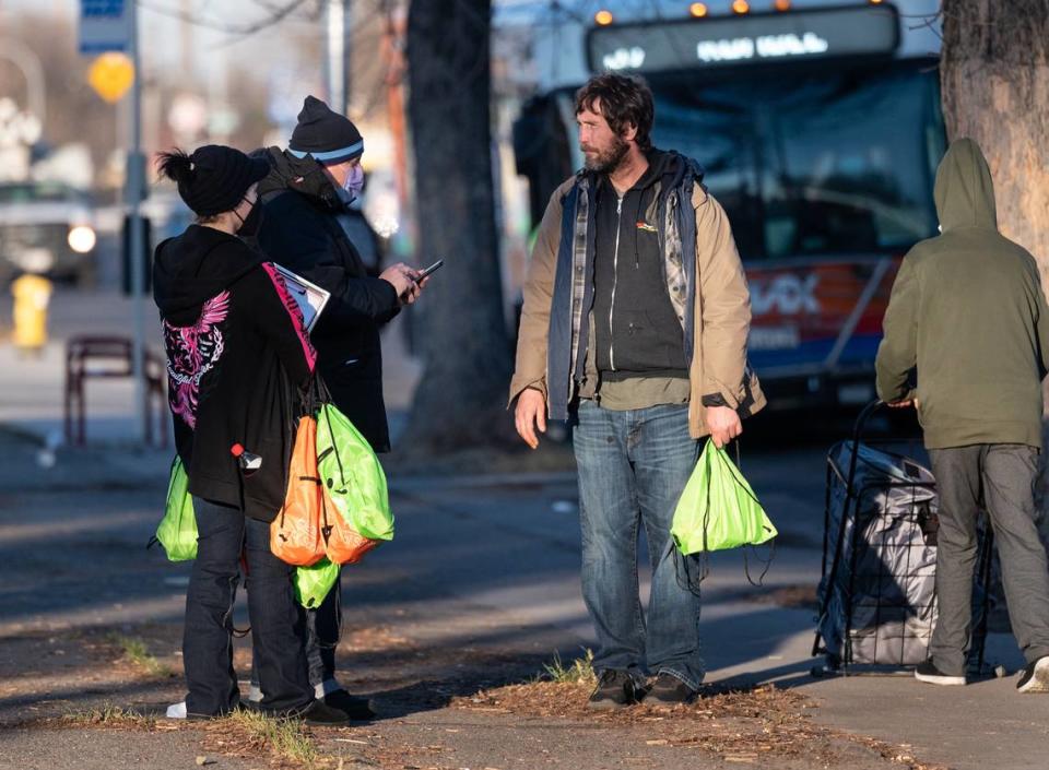 Volunteers Damien Martinez and Emily Owen surveyed unsheltered and asked them a series of questions during the annual count of Stanislaus County’s homeless in Modesto, Calif., on Thursday, Feb. 24, 2022. The U.S. Department of Housing and Urban Development requires local communities to conduct the annual point-in-time count to receive homeless funding.