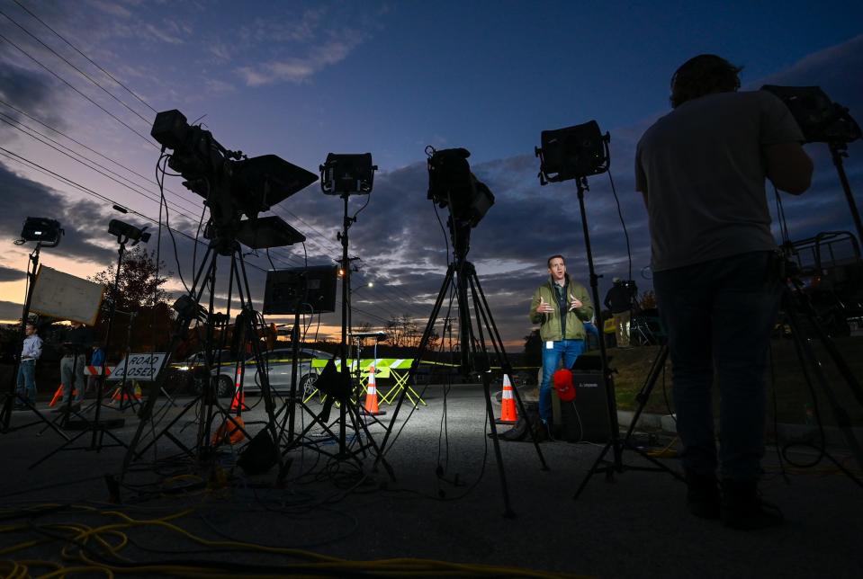 Media crews prepare near Schemengees Bar & Grille Restaurant in Lewiston.