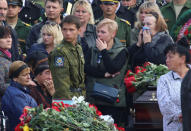 People attend a memorial ceremony before the funeral of victims of an attack on a local college in the city of Kerch, Crimea October 19, 2018. REUTERS/Pavel Rebrov