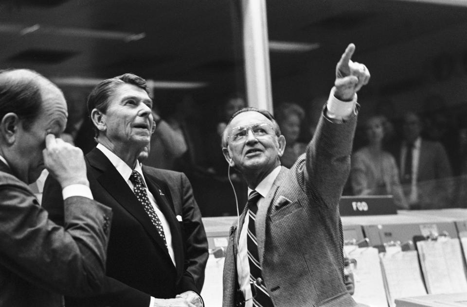 In this Nov. 13, 1981, photo provided by NASA, President Ronald Reagan is briefed by Johnson Space Center Director Christopher C. Kraft Jr., who points toward the orbiter spotter on the projection plotter in the front of the mission operations control room in Johnson Space Center's Mission Control Center, in Houston. This picture was taken just prior to a space-to-ground conversation between STS-2 crew members Joe H. Engle and Richard H. Truly, who were orbiting Earth in the space shuttle Columbia. Kraft, the founder of NASA's mission control, died Monday, July 22, 2019, just two days after the 50th anniversary of the Apollo 11 moon landing. He was 95. (NASA via AP)