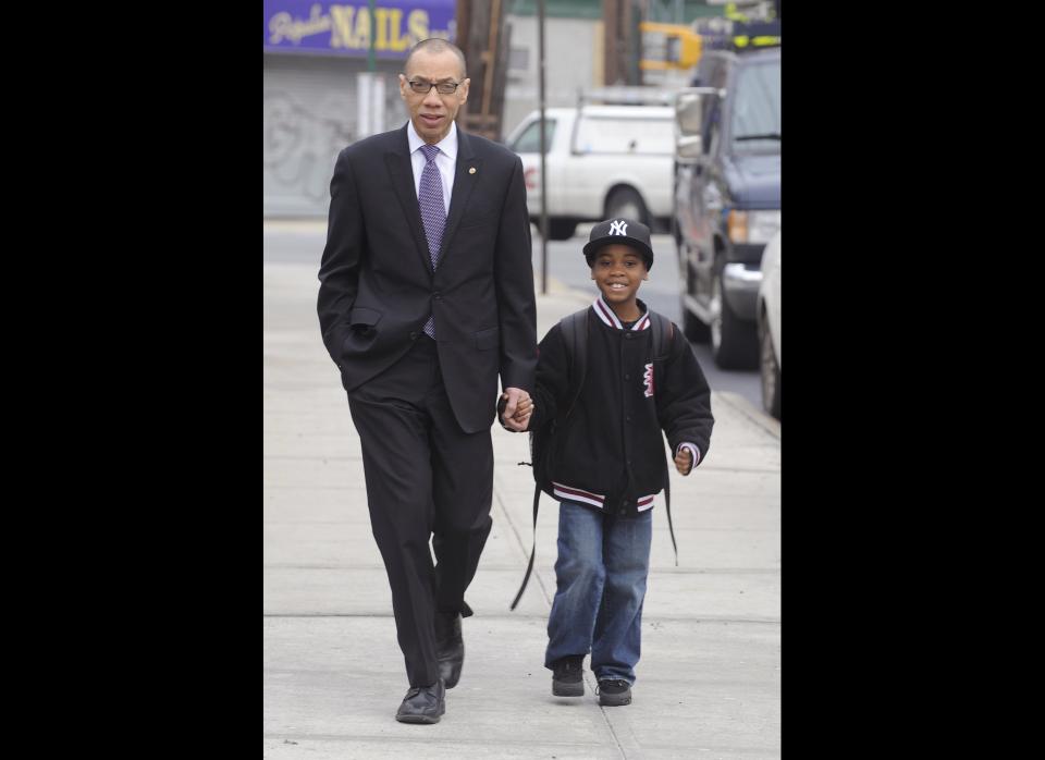 Deputy Mayor Dennis Walcott, left, walks his grandson Justin, 7, to PS 36- St. Albans School, a day after he was nominated by New York City Mayor Michael Bloomberg to replace Cathie Black as schools chancellor, Friday, April 8, 2011 in the Queens borough of New York. (AP Photo/Henny Ray Abrams)