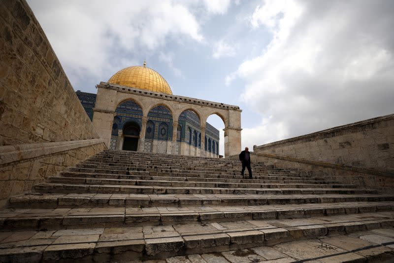 FILE PHOTO: A man walks in front of the Dome of the Rock in Jerusalem's Old City