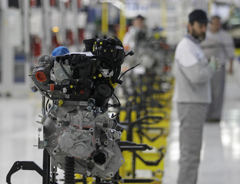 A Serbian factory worker looks at an engine of a Fiat 500 L car in the assembly hall in the new Fiat factory, in Kragujevac, some 100 kilometers (70 miles) south of Belgrade, Serbia, Monday, April 16, 2012. Italian carmaker Fiat has opened a production line in Serbia for its new 500L family model, to expand on the popularity of its two-door 500 city car. Fiat hopes to sell about 160,000 hatchbacks a year produced in this central Serbian town, to take advantage of low wages, tax breaks and government subsidies. (AP Photo/Darko Vojinovic)