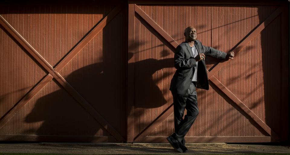 Glynn Turman standing before red barn doors