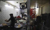 Indian Muslims make sweet flat bread during Eid al-Fitr near the Jama Mosque at the old quarters of New Delhi, India, Monday, May 25, 2020. The holiday of Eid al-Fitr, the end of the fasting month of Ramadan, a usually joyous three-day celebration has been significantly toned down as coronavirus cases soar. (AP Photo/Manish Swarup)