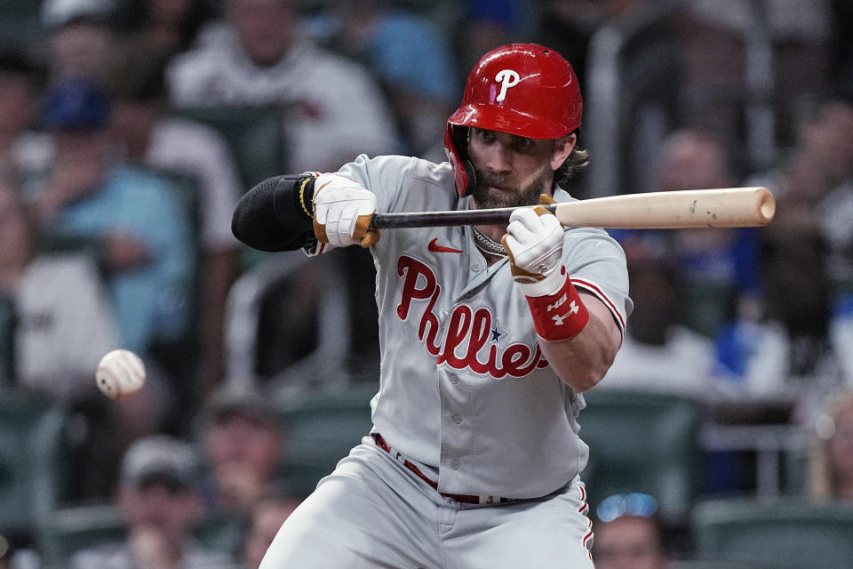 Philadelphia Phillies' Bryce Harper lays down a bunt for a single during the seventh inning of the team's baseball game against the Atlanta Braves, Thursday, May 25, 2023, in Atlanta. (AP Photo/John Bazemore)