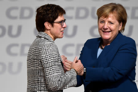 Annegret Kramp-Karrenbauer is embraced by German Chancellor Angela Merkel after being elected as the party leader during the Christian Democratic Union (CDU) party congress in Hamburg, Germany, December 7, 2018. REUTERS/Fabian Bimmer