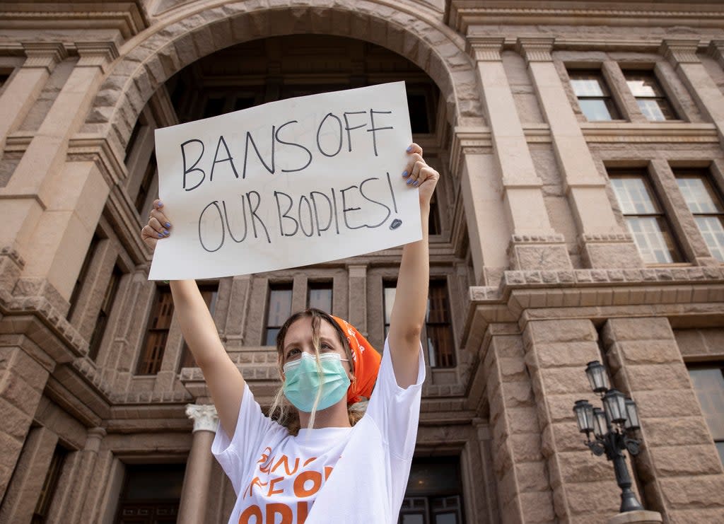File: A protestor holds a placard during a rally against the Texas abortion law (AP)