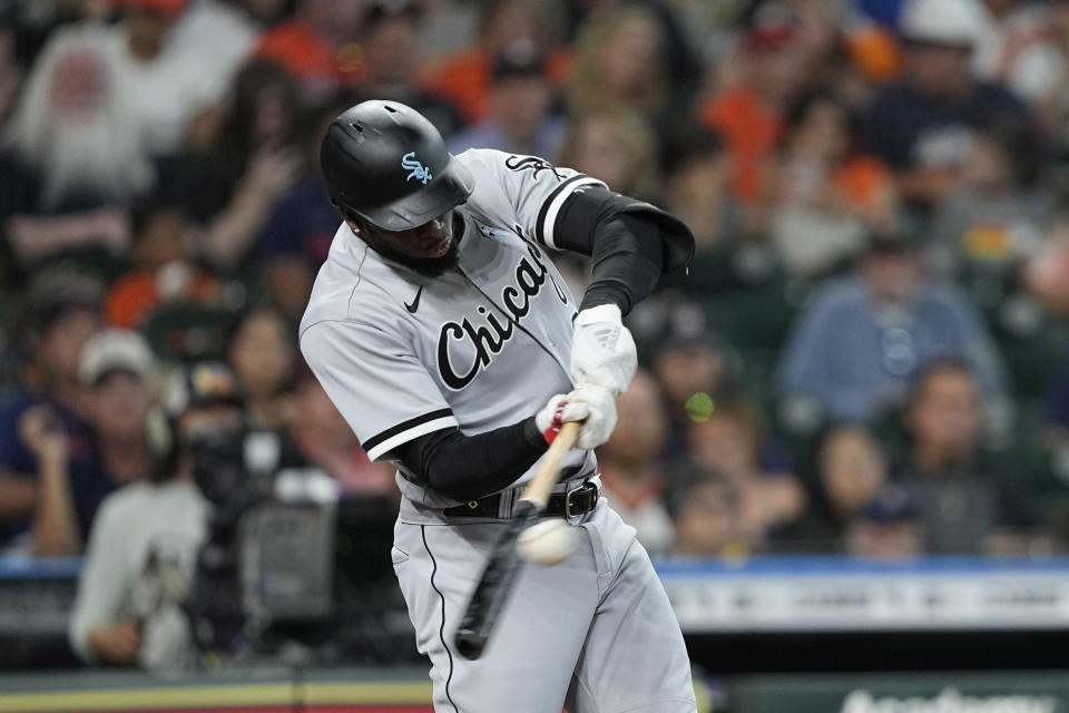 Chicago White Sox's Luis Robert hits a RBI-double against the Houston Astros during the fifth inning of a baseball game Sunday, June 19, 2022, in Houston. (AP Photo/David J. Phillip)