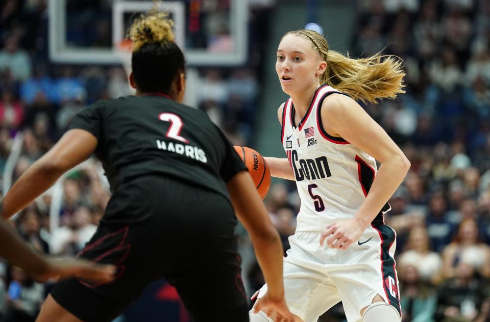 UConn guard Paige Bueckers tries to elude Louisville forward Nyla Harris in the second half. Bueckers scored 20 points in the Huskies' victory Saturday in Hartford, Connecticut. Harris scored seven points.
