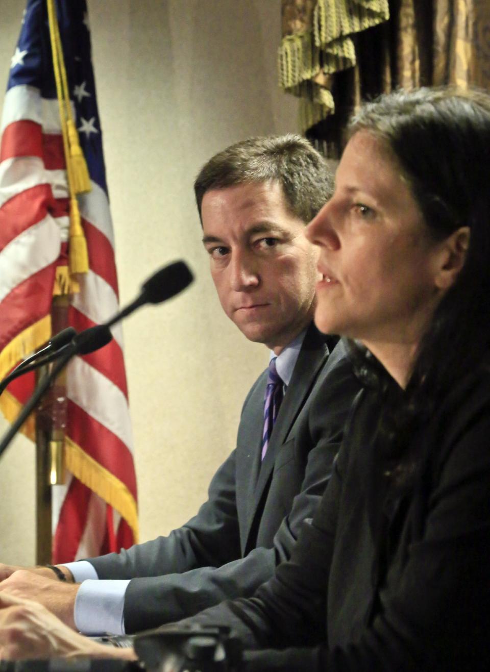 FILE - In this Friday, April 11, 2014, file photo, journalist Glenn Greenwald, left, listens as Laura Poitras speaks during a news conference following the Polk Awards luncheon, in New York. The Washington Post and The Guardian won the Pulitzer Prize in public service Monday, April 14, 2014, for revealing the U.S. government’s sweeping surveillance efforts in stories based on thousands of secret documents handed over by National Security Agency leaker Edward Snowden. The reports were published by Barton Gellman of The Post and Greenwald, Poitras and Ewan MacAskill of The Guardian, all of whom shared a George Polk Award for national security reporting. (AP Photo/Bebeto Matthews, File)