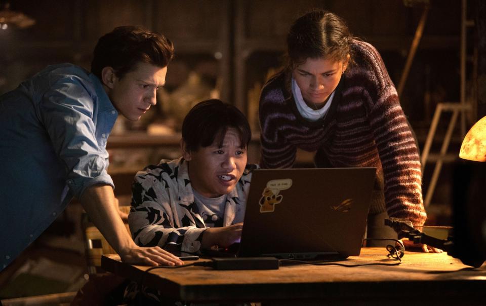 Peter and his friends looking at a laptop