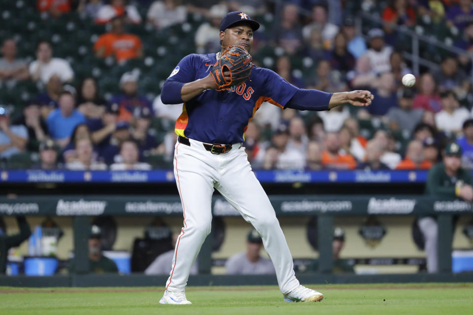 Houston Astros starting pitcher Framber Valdez makes the throw to first for the out on the infield grounder by Oakland Athletics designated hitter Abraham Toro during the fourth inning of a baseball game Wednesday, May 15, 2024, in Houston. (AP Photo/Michael Wyke)