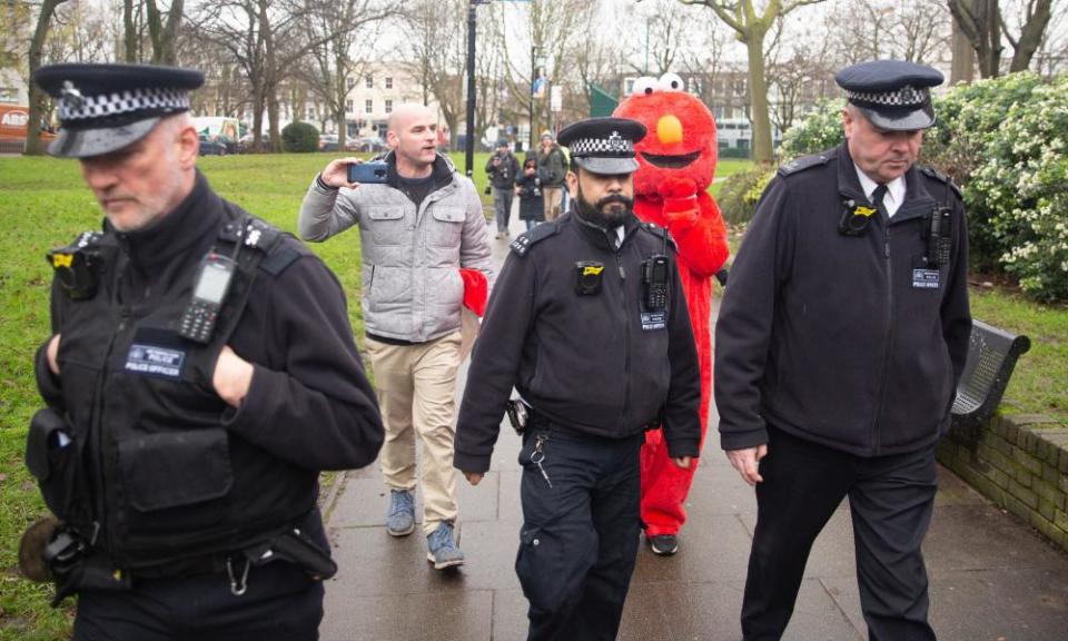 An Elmo with a police escort.