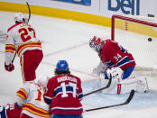 Calgary Flames' Josh Leivo (27) scores the third goal against Montreal Canadiens goaltender Jake Allen (34) during the third period of an NHL hockey game Wednesday, April 14, 2021 in Montreal. (Ryan Remiorz/Canadian Press via AP)