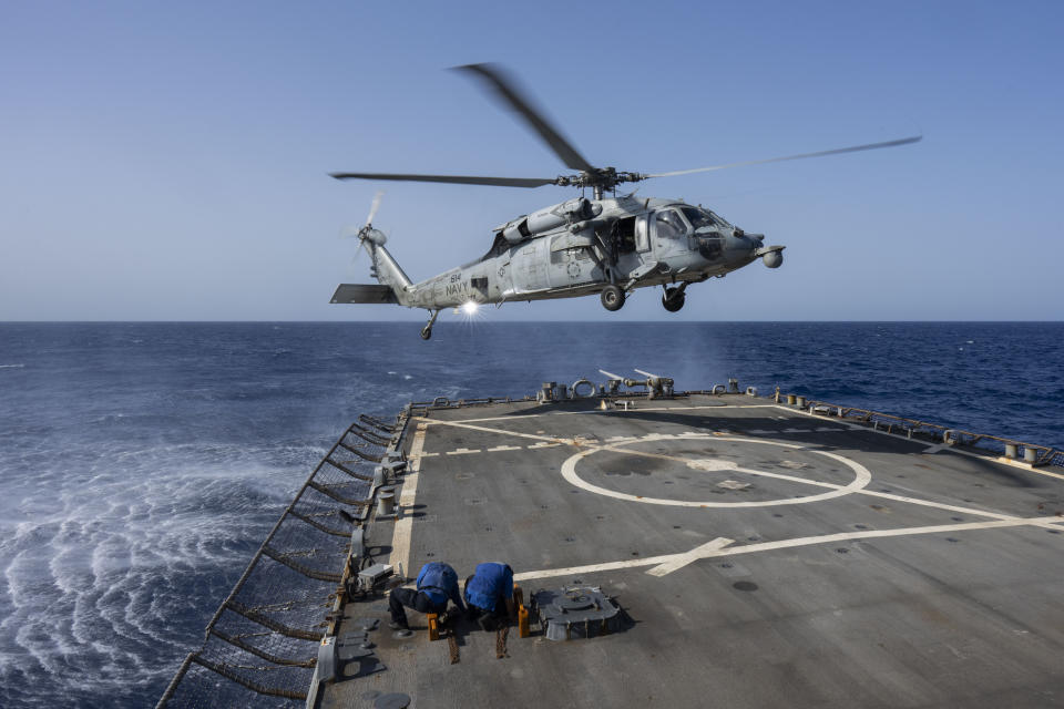 An HSC-7 helicopter lands on the Arleigh Burke-class guided missile destroyer USS Laboon in the Red Sea, Wednesday, June 12, 2024. (AP Photo/Bernat Armangue)