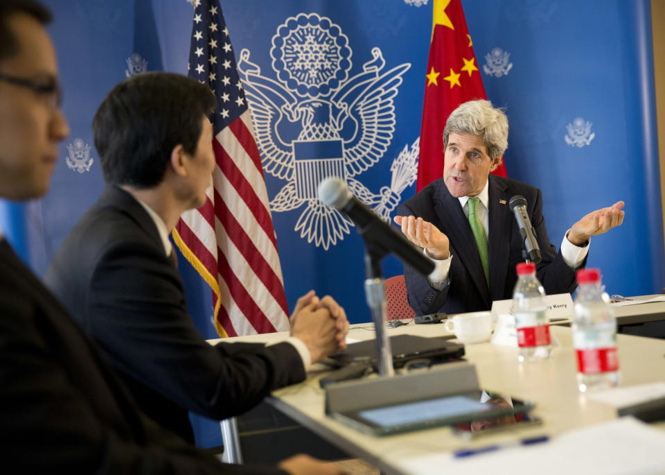 U.S. Secretary of State John Kerry, right, gestures during a discussion with Chinese bloggers on a number of issues, including internet freedom, Chinese territorial disputes with Japan, North Korea, and human rights, on Saturday, Feb. 15, 2014, in Beijing, China. (AP Photo/Evan Vucci, Pool)