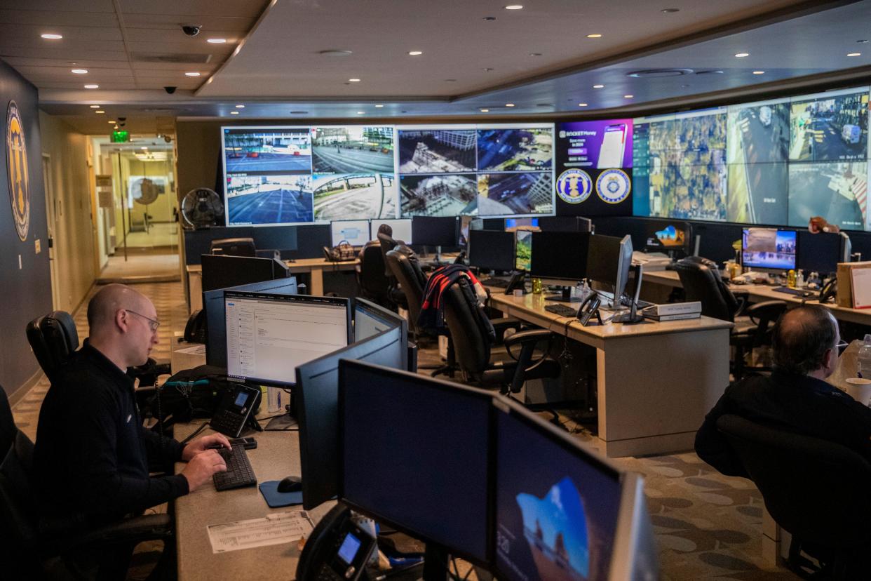 Memphis Police Department real time crime center staff work on computers as live camera feeds from around the city are seen on a wall of screens in front of them on Wednesday, February 14, 2024.