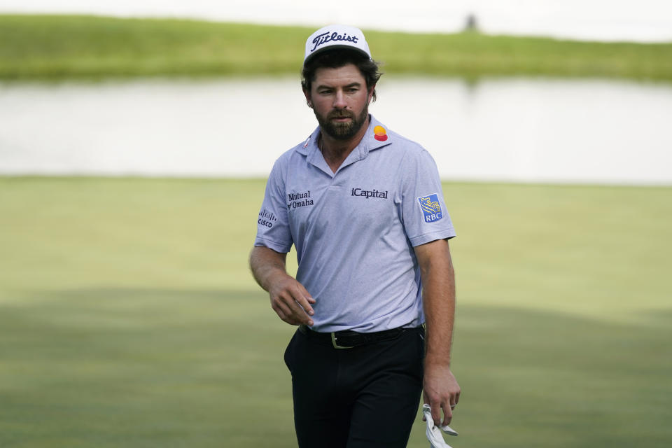 Cameron Young walks off the 18th green after finishing his third round of the John Deere Classic golf tournament, Saturday, July 8, 2023, at TPC Deere Run in Silvis, Ill. (AP Photo/Charlie Neibergall)