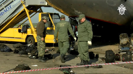 A still image, taken from a video footage and released by Russia's Investigative Committee on May 6, 2019, shows investigators at the scene of an incident involving an Aeroflot Sukhoi Superjet 100 passenger plane at Moscow's Sheremetyevo airport, Russia. The Investigative Committee of the Russian Federation/Handout via REUTERS