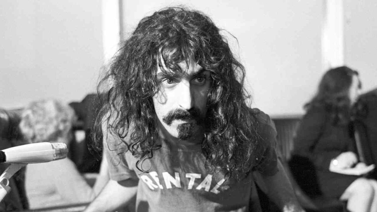  Frank Zappa sitting on a chair and leaning forward 