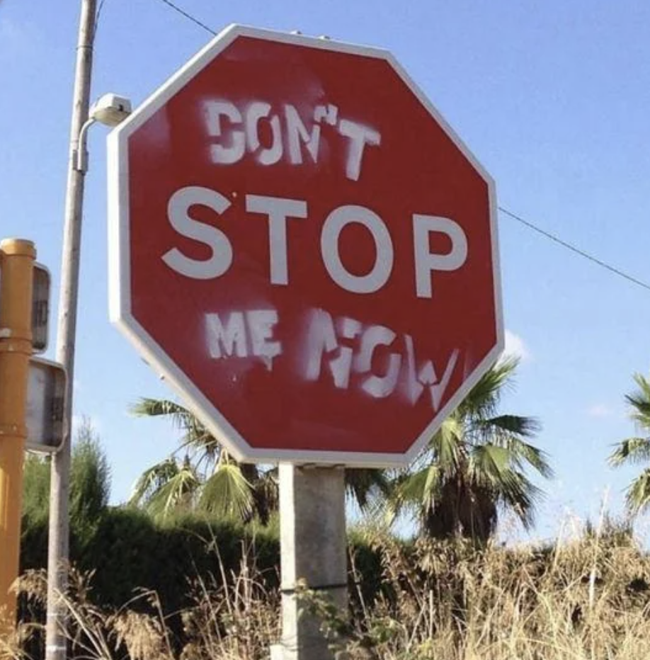 A modified stop sign with the phrase "DON'T STOP ME NOW" written on it