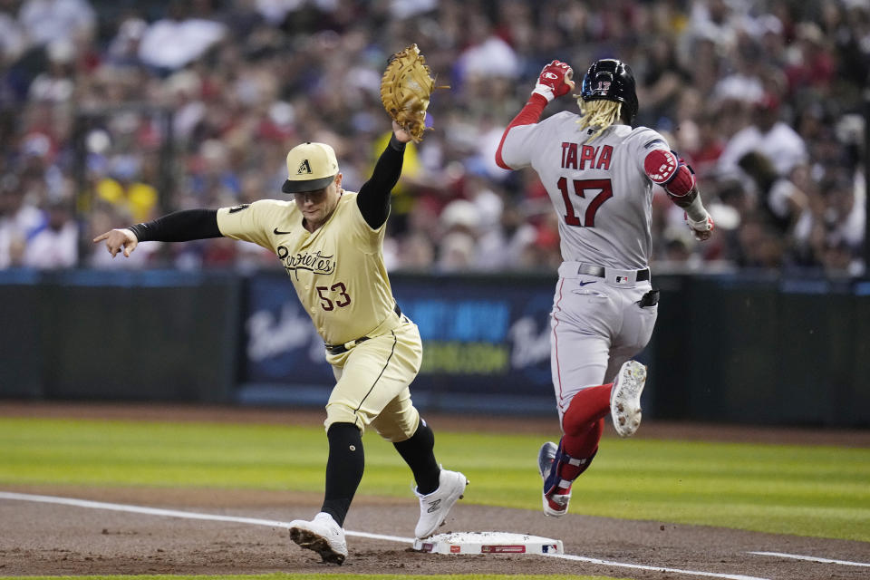 Arizona Diamondbacks first baseman Christian Walker (53) makes a catch for the out at first base against Boston Red Sox's Raimel Tapia (17) during the first inning of a baseball game Friday, May 26, 2023, in Phoenix. (AP Photo/Ross D. Franklin)