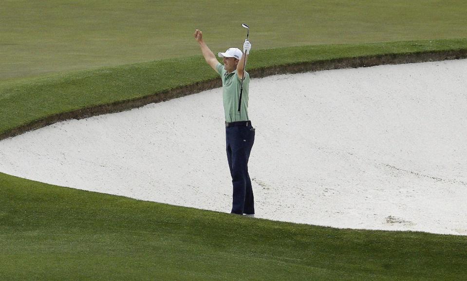 Jordan Spieth celebrates after chipping in for an birdie from a bunker on the fourth hole during the fourth round of the Masters golf tournament Sunday, April 13, 2014, in Augusta, Ga. (AP Photo/Charlie Riedel)