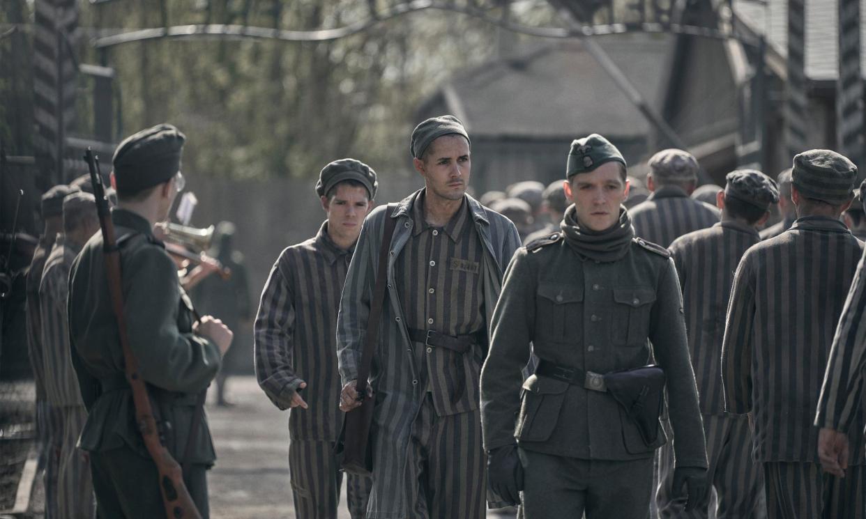 <span>Lali Sokolov (Jonah Hauer-King) walks through Auschwitz with the Nazi officer Stefan Baretzki (Jonas Nay).</span><span>Photograph: Martin Mlaka/Sky UK</span>